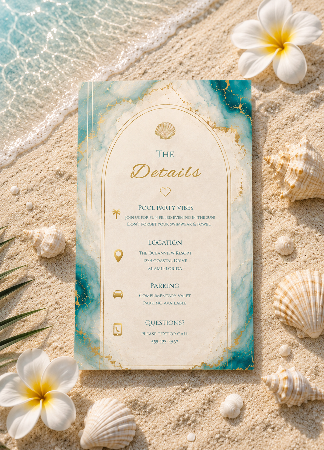 A beach-themed wedding details card with a teal and gold marble design, styled on sand with seashells and white flowers.