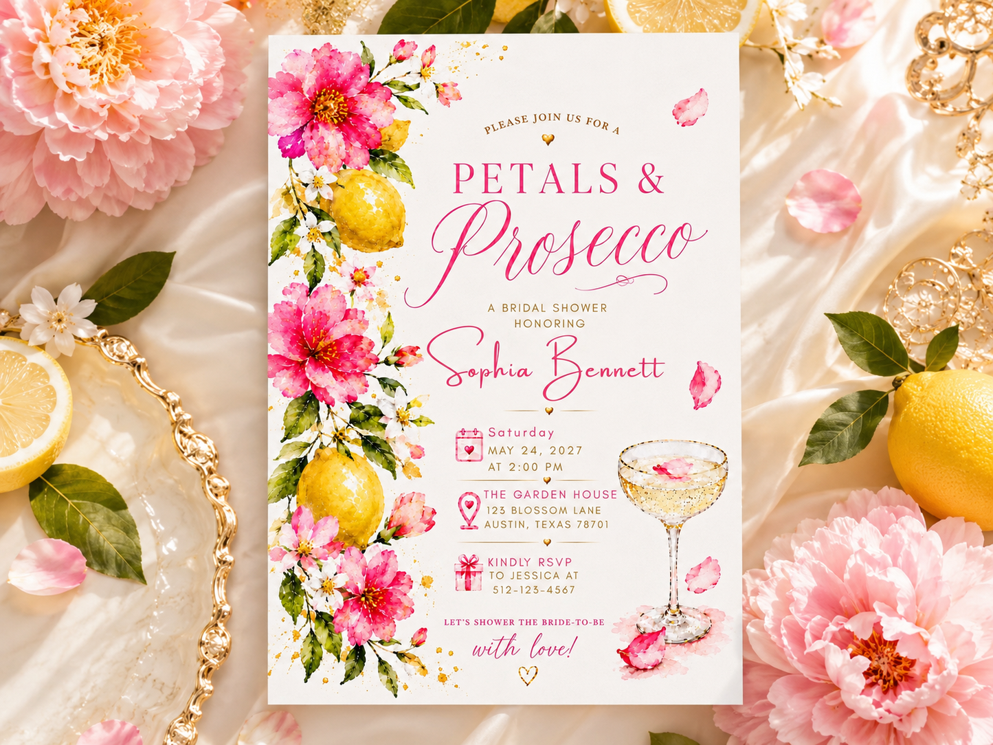 A floral bridal shower invitation card styled in a flat lay with pink peonies, lemons, gold jewelry, and a champagne glass illustration. The card reads 'Petals & Prosecco' and 'Sophia Bennett'.