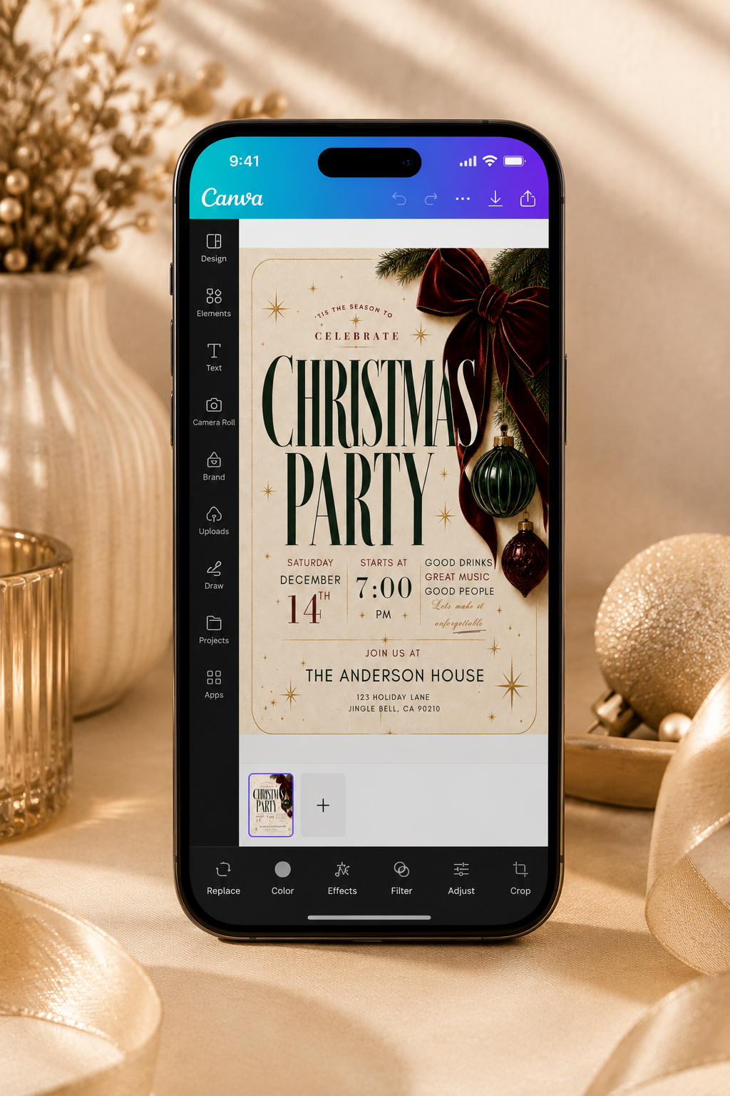 A smartphone displaying a Canva Christmas party invitation design, styled on a warm beige fabric surface with holiday decorations including a gold ornament, dried flowers, and ribbons.